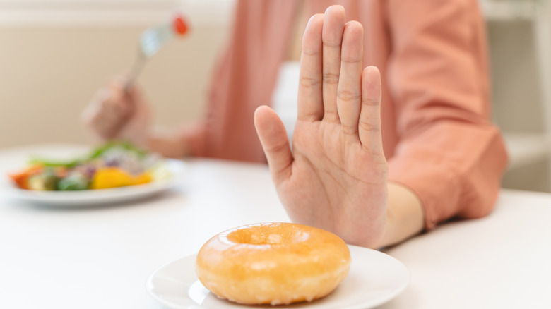 A woman saying no to a pastry
