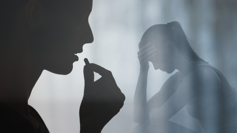 woman swallowing a pill and experiencing side effects
