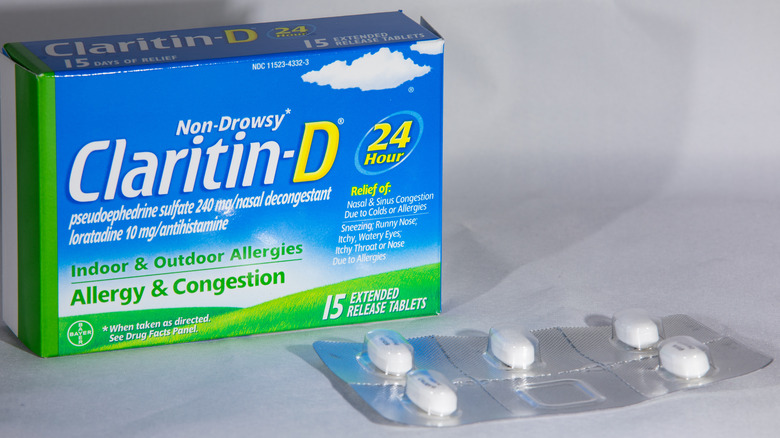 A box of Claritin D with a blister pack of tablets beside it