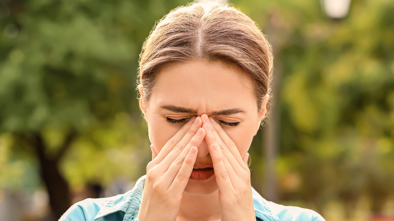 A woman pinching her nose