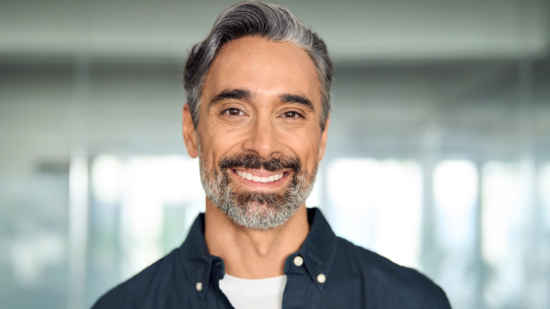 A middle-aged man smiling at the camera