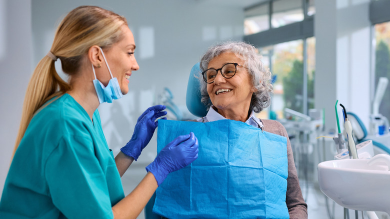 A dental hygienist working with an older woman