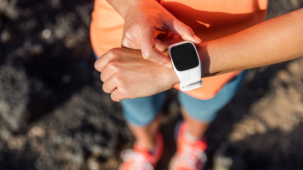 Runner checking heart rate on watch