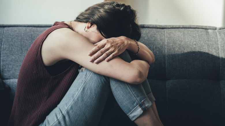 depressed woman on couch