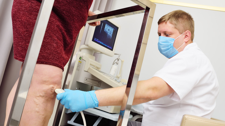 A doctor looks at someone's veins