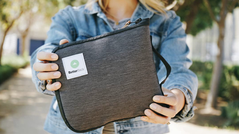 Hands holding BetterBack pack