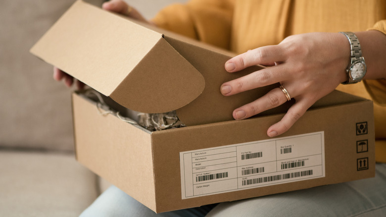 woman opening delivered package at home