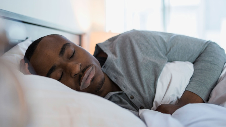 man sleeping with mouth tape