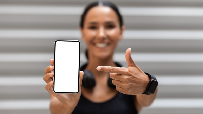 woman pointing to smart phone