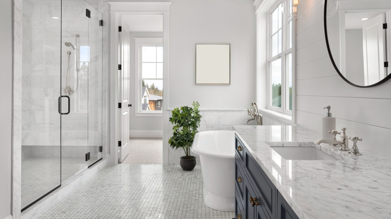 White bathroom with shower, bathtub and sink