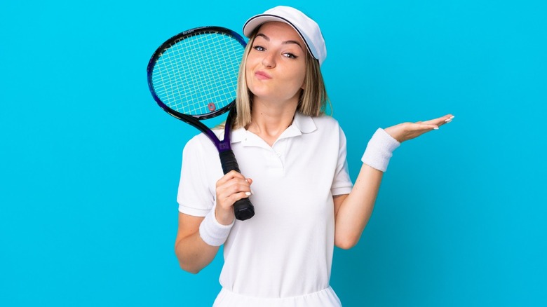 woman holding tennis racket