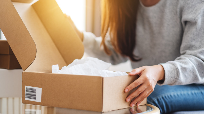 woman opening a package