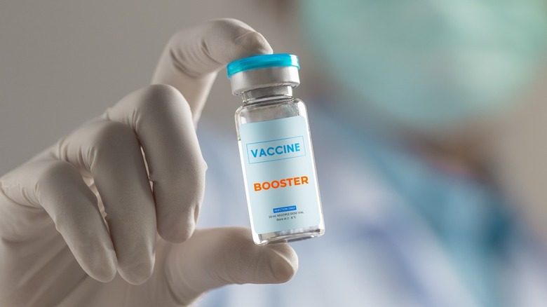 Doctor holds COVID booster vial