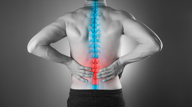 Man touching his spine and back