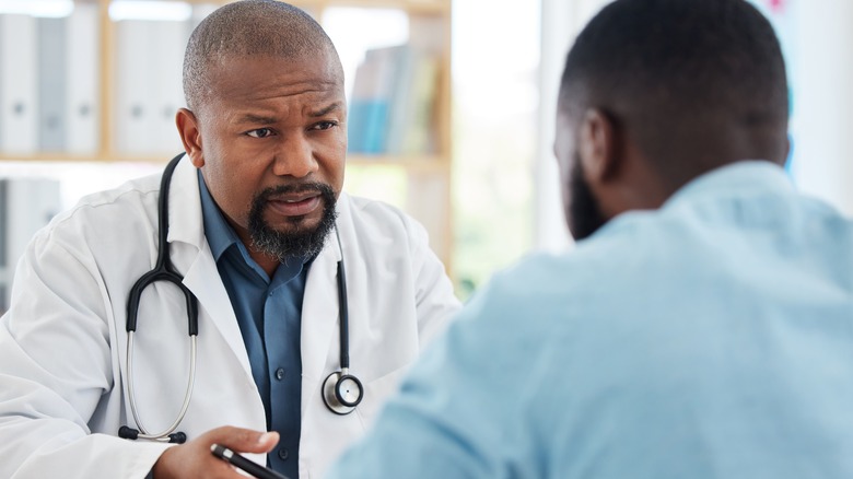 doctor having serious talk with patient
