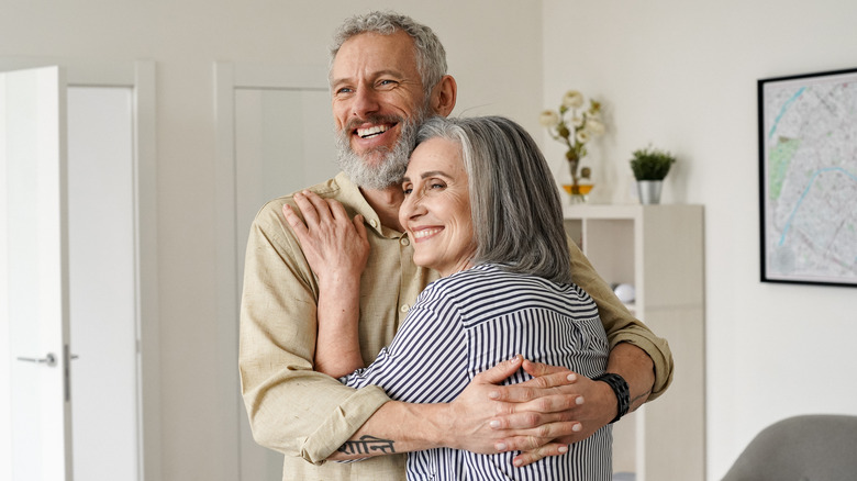 Two older people hugging