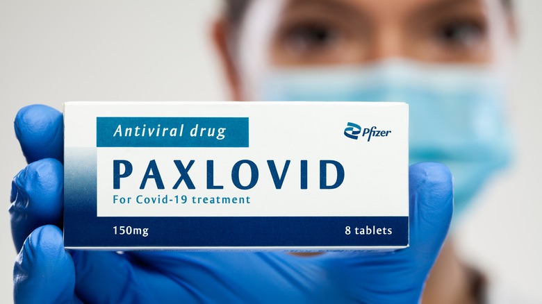 doctor holding box of Paxlovid