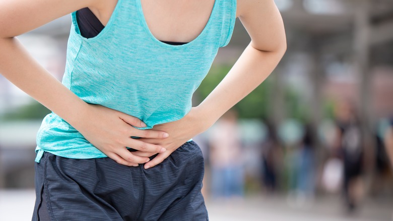 Woman holding stomach