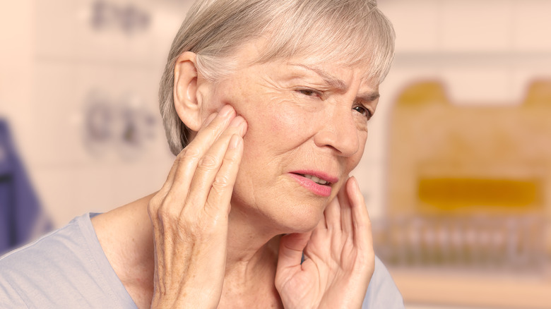 older woman looking at face