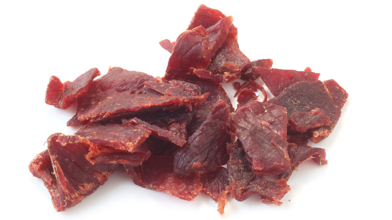 Pile of beef jerky on white background