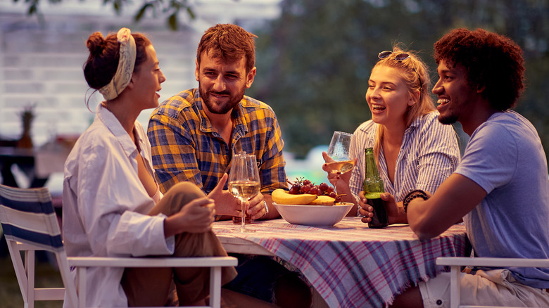 Group of friends drinking beer and wine outdoors