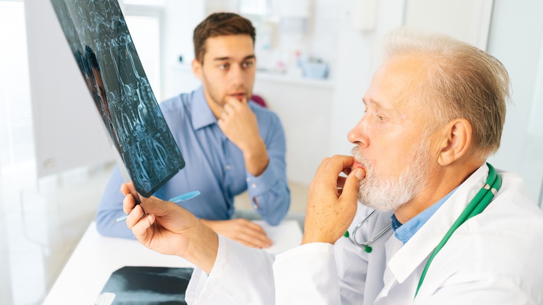 Doctor and patient examining X-ray