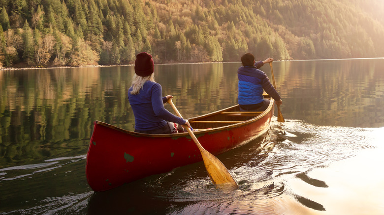 Two people in a canoe on a calm river