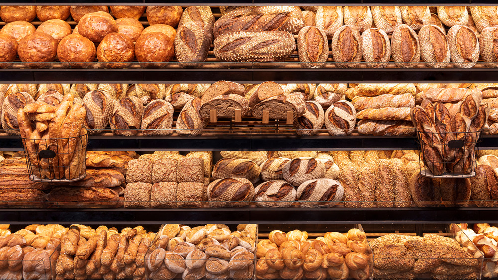 a variety of bread choices in the bakery aisle 
