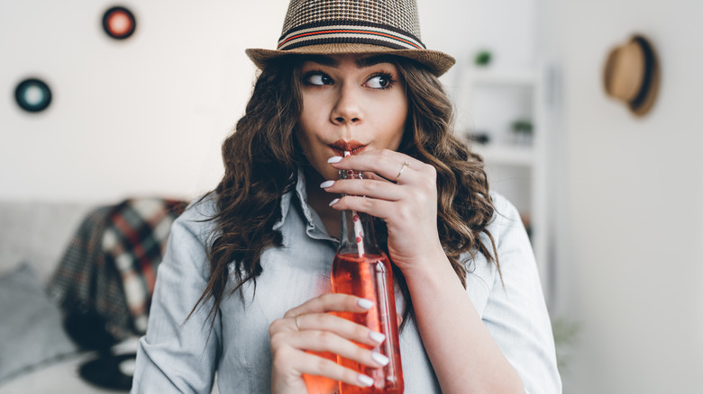 Young woman drinking soda