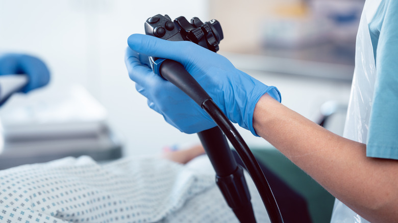 Gloved hand holding endoscope
