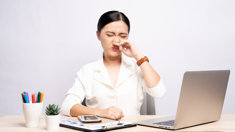 woman wiping runny nose