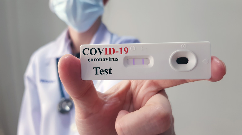 Someone holds a COVID test