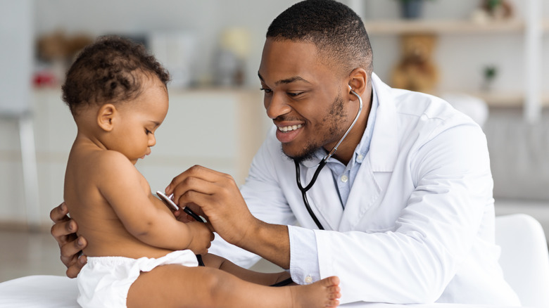 baby being checked by pediatrician