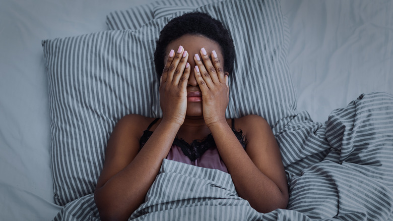Sleepy woman lying in bed 