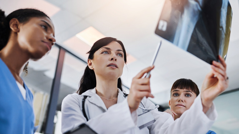 medical providers looking at leg x-ray image