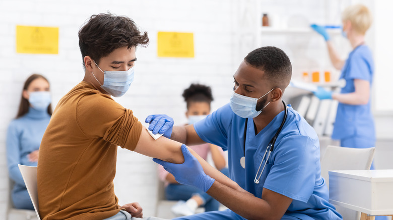 A medical provider giving a patient a vaccine injection