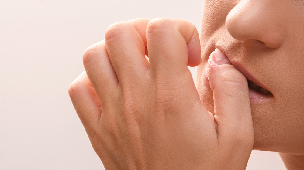 Woman biting nails 