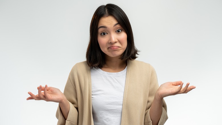 Woman questioning and scratching head