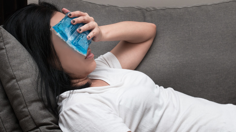 Woman with ice pack on head