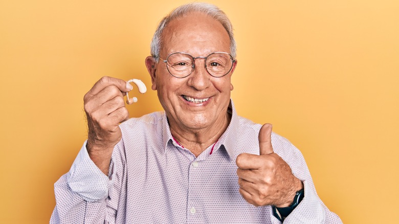 Senior using hearing aids