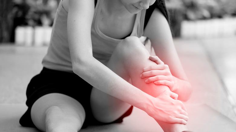 Female runner holding onto her throbbing shin