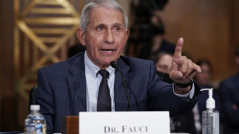 Dr. Fauci addressing the public at a podium 