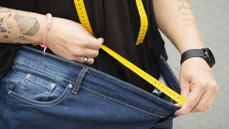 woman's pants loosened after weight loss