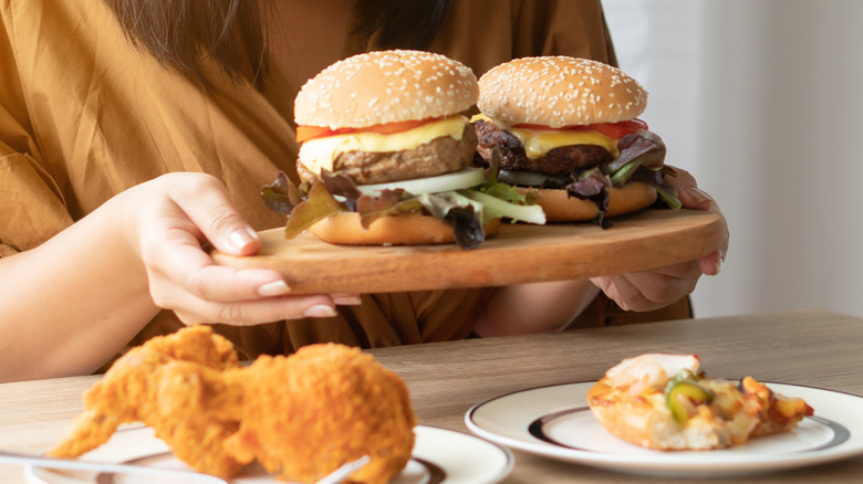 woman binge eating junk foods