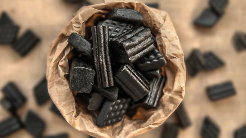 a paper bag filled with black licorice candy 