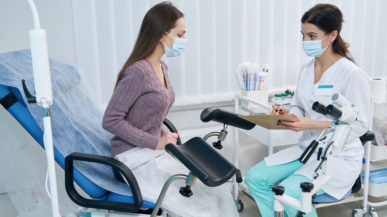 gynacologist noting down patient's symptoms