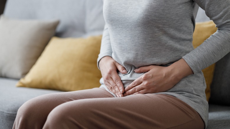 woman holding pelvic area