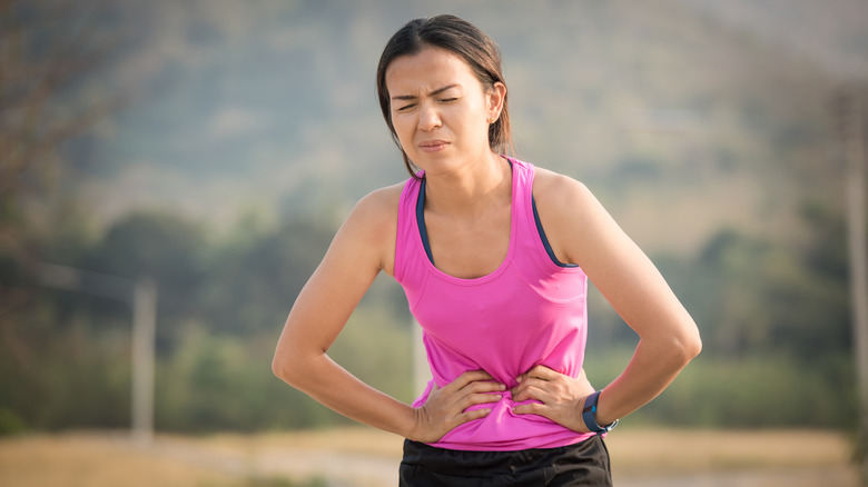 Exercising woman in pain from menstrual cramps