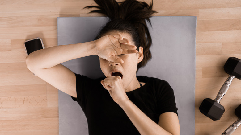 Tired woman unmotivated to work out
