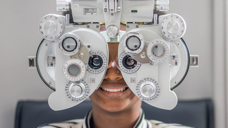 Black teen and eye exam machine